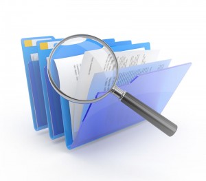 magnifying glass and file folders